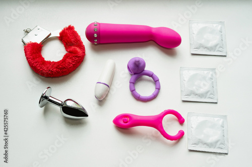 Set of erotic toys. Sex toy for adult, dildo vibrator, cock ring, condoms, handcuffs, plug. Various sex toys on a white background.