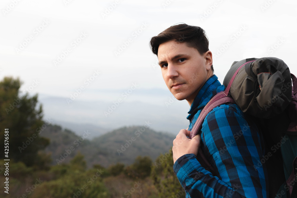 young man with backpack in the mountain