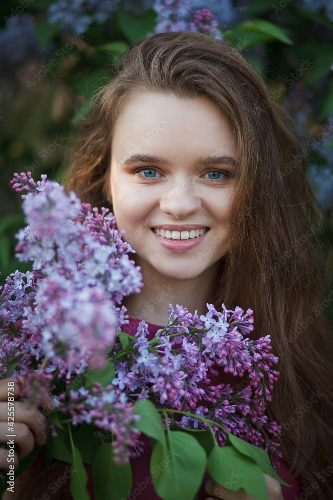 beautiful girl in a short purple dress walks in the lilac garden, leather dress, lilac bloom beautiful girl in a short purple dress walks in the lilac garden, leather dress, lilac bloom