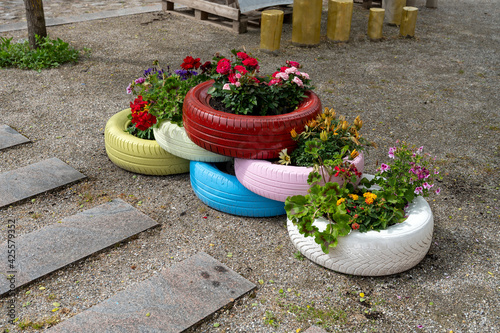 6 colorful tires with flowers in them - shot from an obliquely angle