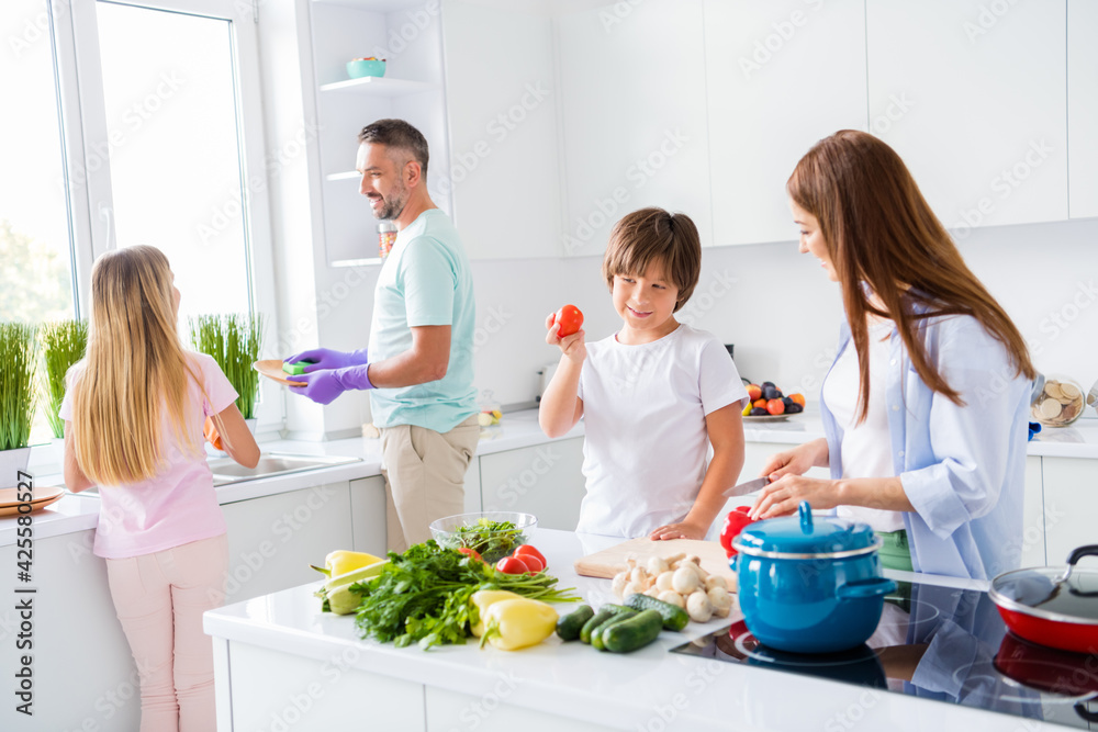 Photo portrait of full family members spending time on kitchen preparing dishes for breakfast helping each other