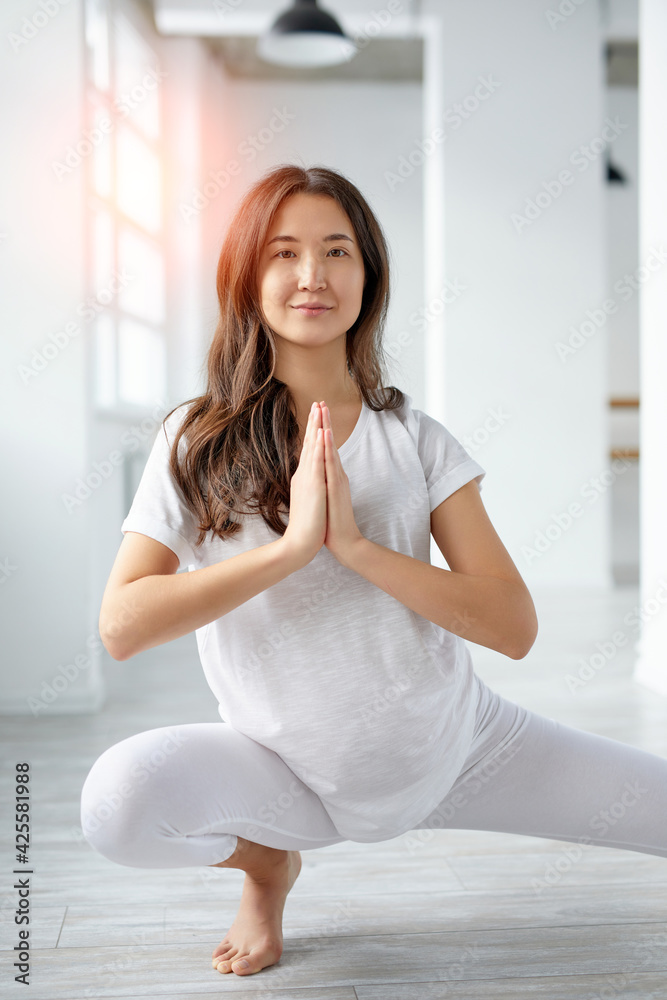 young pretty pregnant woman in sportive outfit stretching body in studio young pretty pregnant woman in sportive outfit stretching body in studio
