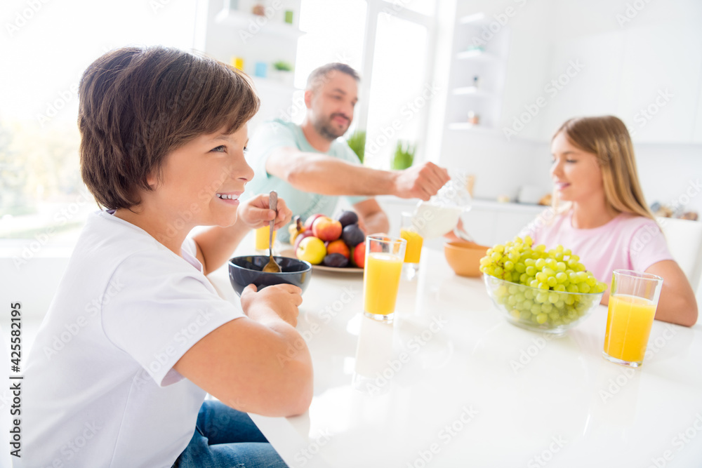 Photo of happy lovely smiling family sit table eating food breakfast enjoying lazy morning having great time at home house
