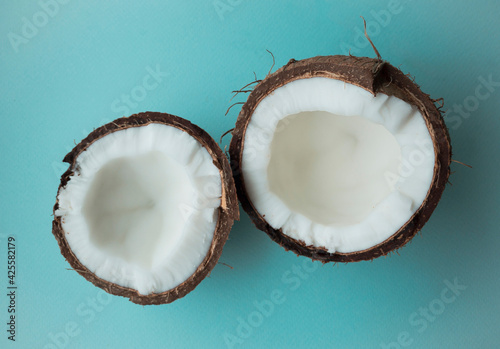 Coconut tree fruit coconut split into two halves isolated on blue background