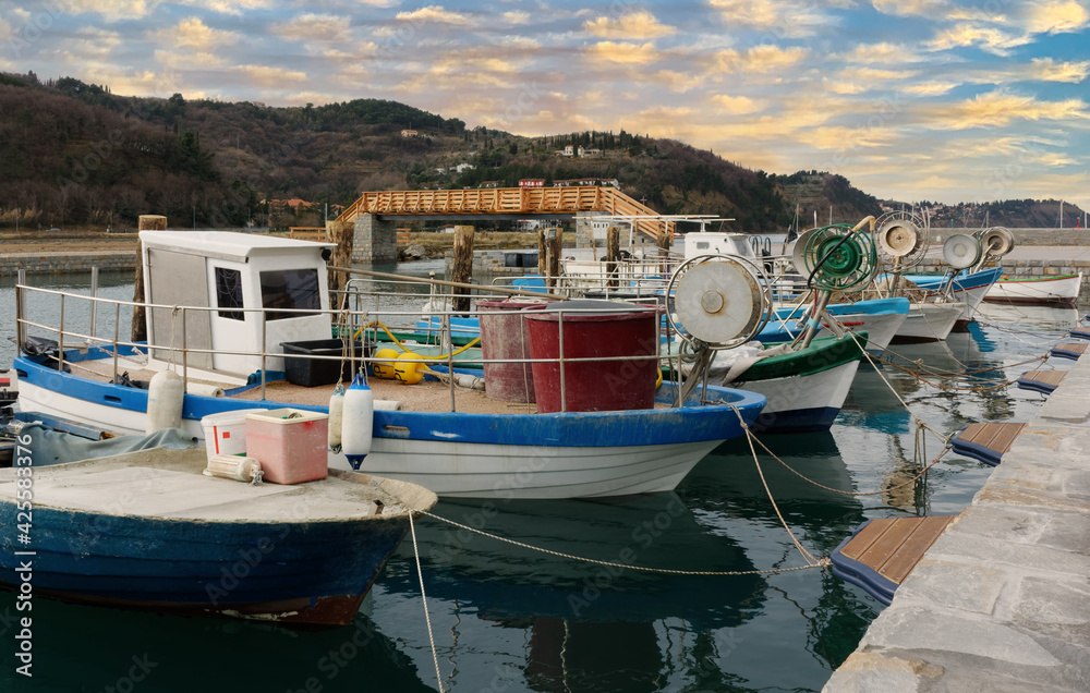 Obraz premium Moored fishing boats at sunset near Strunjan, Slovenia