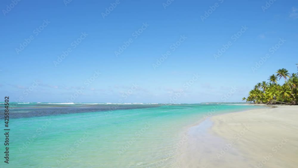 Maldives beach background stock video. Clean a tropical beach with white sand and transparent blue seawater and waves landscape. Maldives beach background stock video. Clean a tropical beach with white sand and transparent blue seawater and waves landscape.