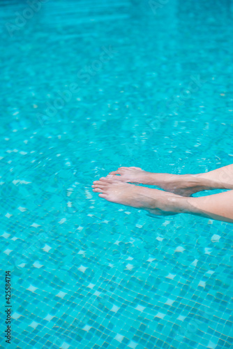 Vacation time in summer. Woman leg in the pool.