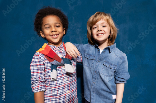 Bild auf Leinwand Multiethnic boys classmates best friends embracing in tolerance unity, anti racism concept