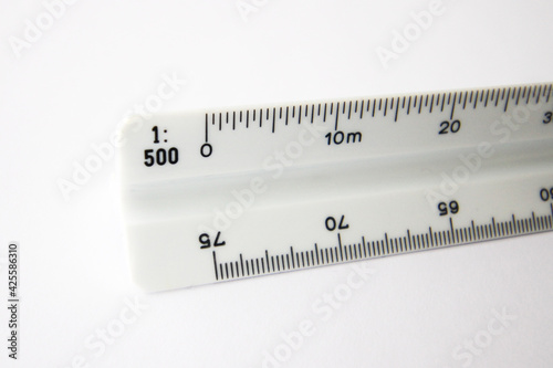 Close up of a triangular scale ruler on white background. Scale 1:500.