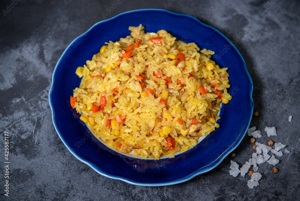 Risotto with chicken and vegetables. A plate of rice with vegetables. Selective focus.