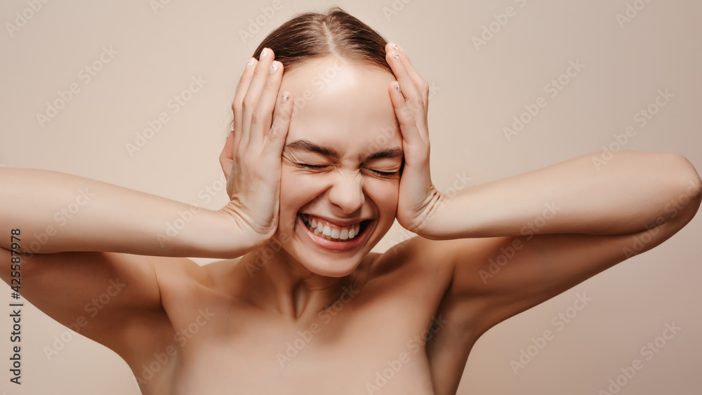 Emotional portrait of young woman who pressed her hands to her head