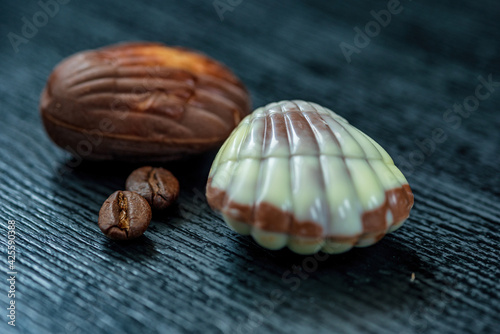 Figures of Belgian chocolate on a dark wooden background close-up.