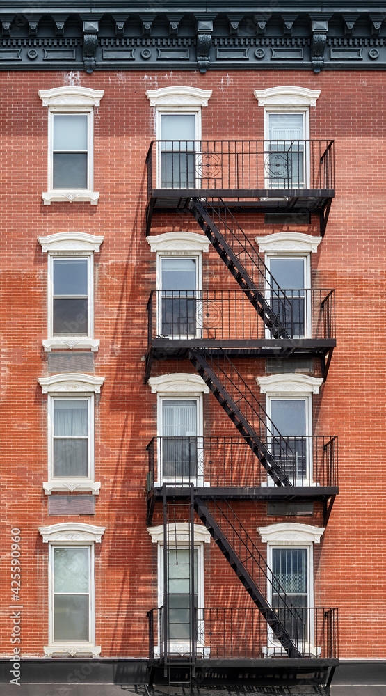 Obraz premium Old brick building with fire escape, New York City, USA.