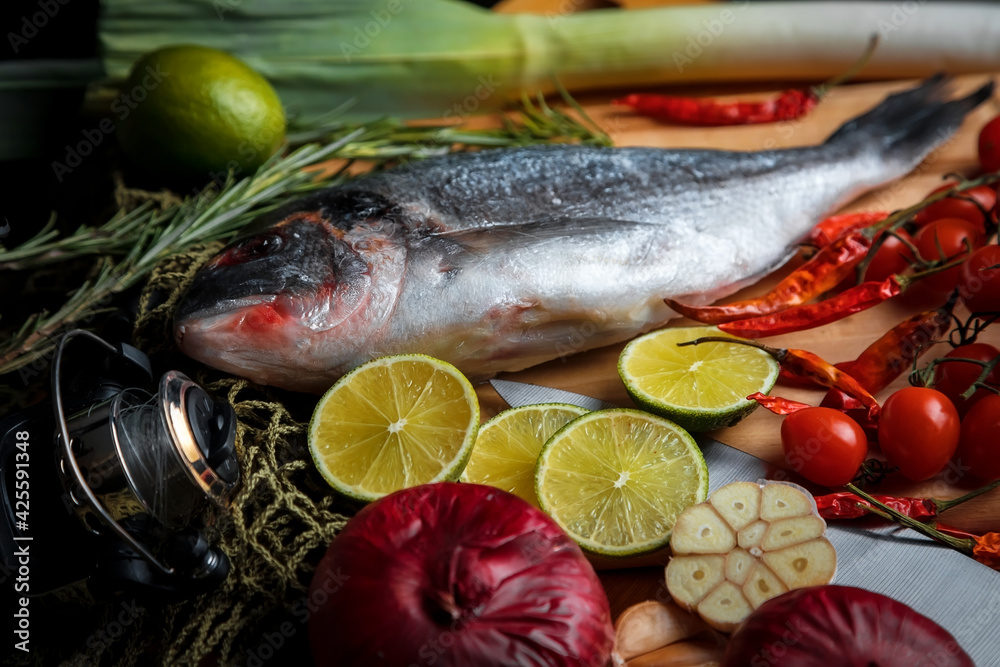Fresh sea fish with olive oil, spices and lemon ready for cooking. Dorado or sea bream fish. Fresh sea fish with olive oil, spices and lemon ready for cooking. Dorado or sea bream fish.