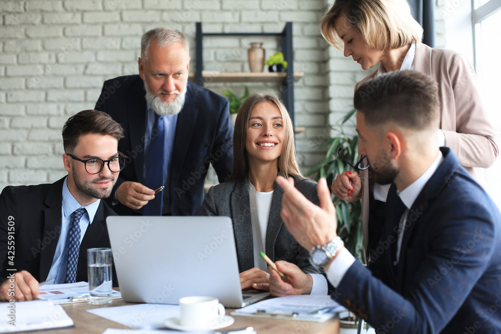 Startup business team on meeting in modern bright office interior and working on laptop. Startup business team on meeting in modern bright office interior and working on laptop.