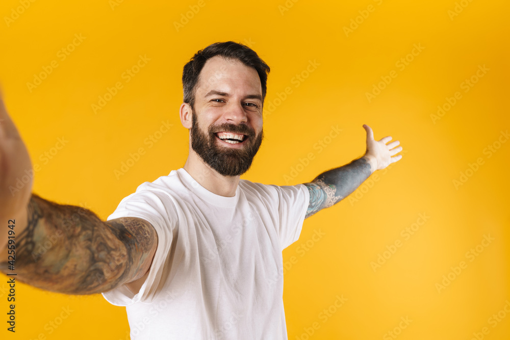 Fototapeta premium Portrait of a happy brunette bearded man standing