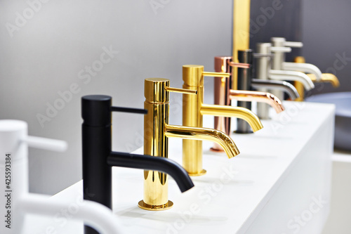 Plumbing and kitchen faucets at exhibition in store photo