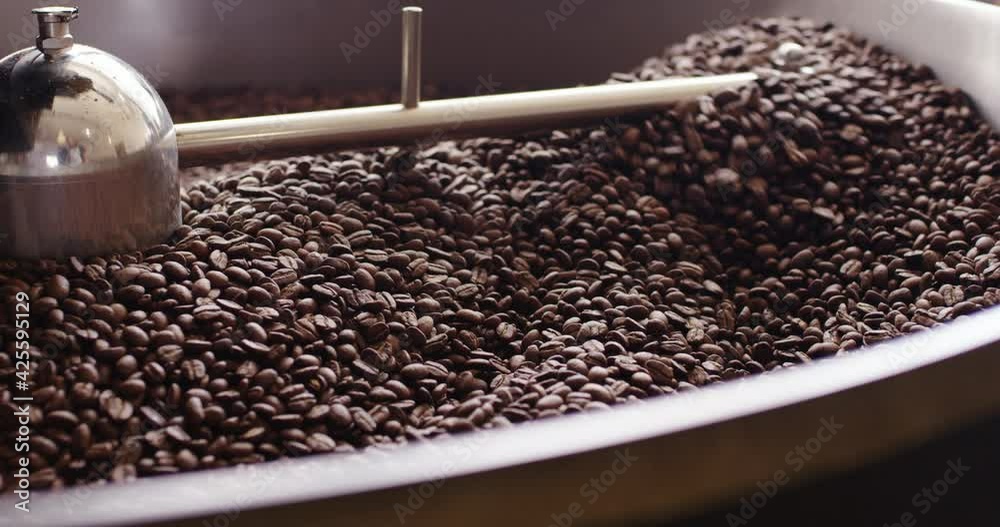 Roasting coffee beans in roaster, side closeup view