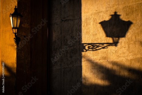 Old lantern in warm evening light in an old downtown street photo