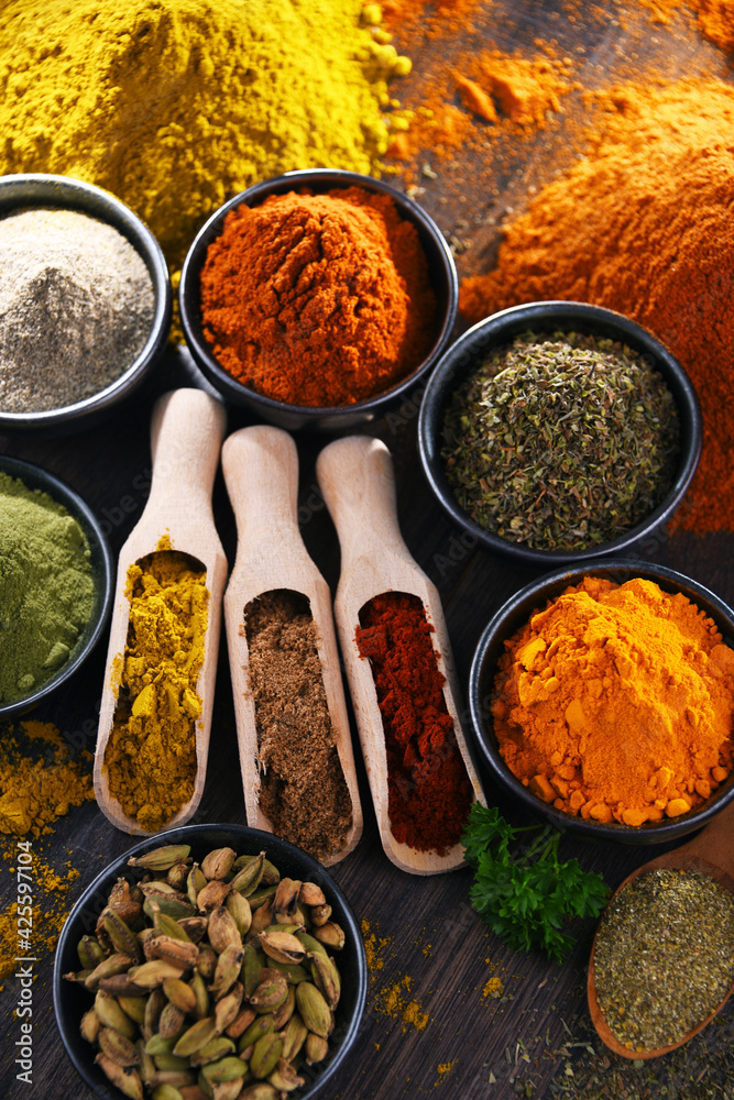 Variety of spices on wooden kitchen table. Variety of spices on wooden kitchen table.