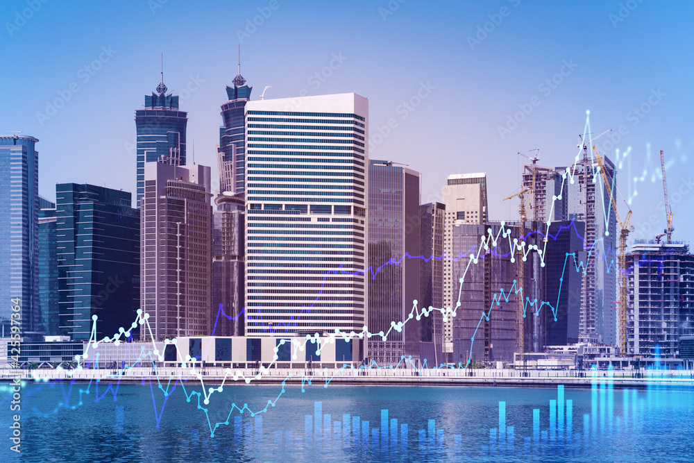 Fototapeta premium Skyscrapers of Dubai business downtown. International hub of trading and financial services of Western Asia. FOREX graph and chart concept. Double exposure. Dubai Canal waterfront.