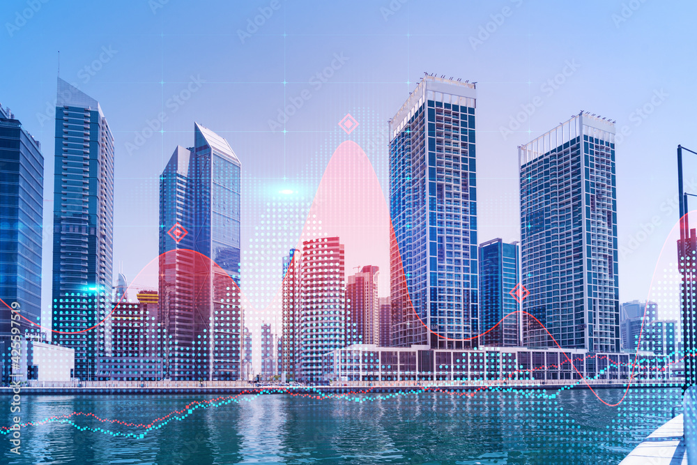 Fototapeta premium Skyscrapers of Dubai business downtown. International hub of trading and financial services of Western Asia. FOREX graph and chart concept. Double exposure. Dubai Canal waterfront.