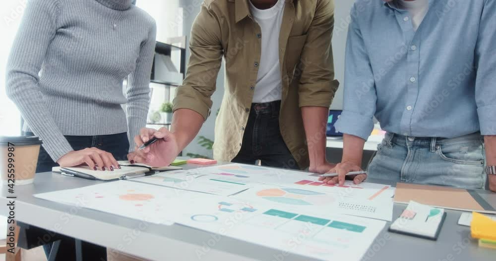 Young Asian business financial team work together in project brainstorm meeting. Cooperate teamwork, strategy planning, small business startup company, or office coworker collaborate concept, panning