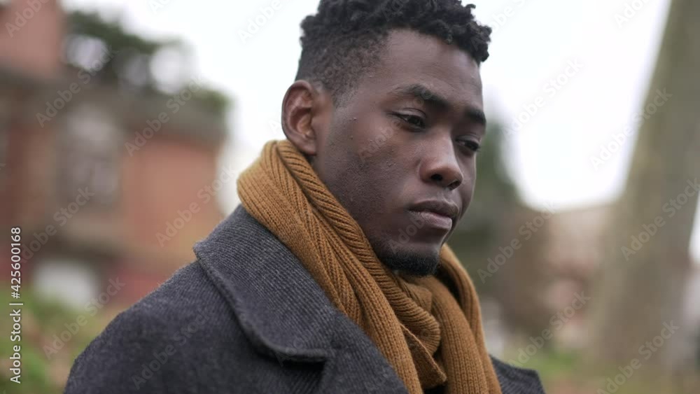 Pensive black African man close-up face thinking about issues Pensive black African man close-up face thinking about issues