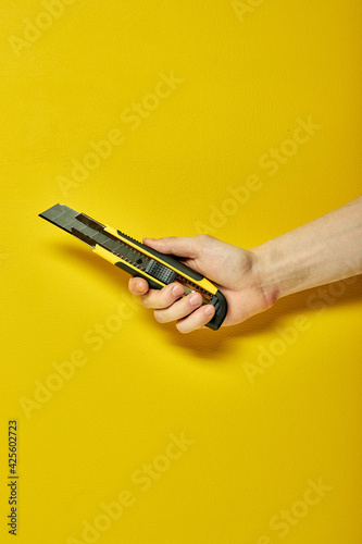 Swiss knife close-up isolated on yellow background