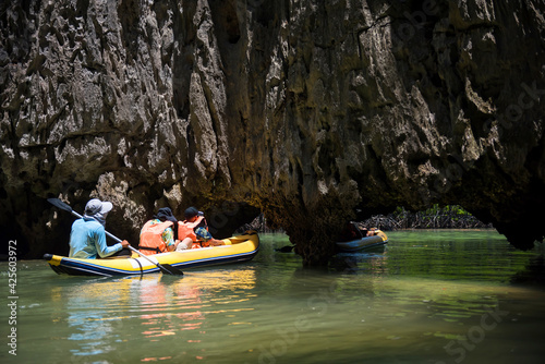 tourist canoe through small cave at Phang Nga bay