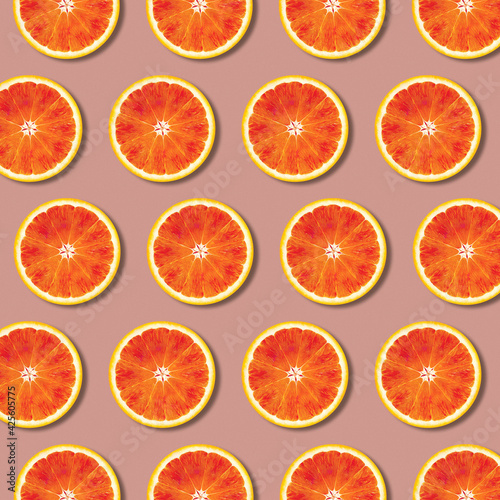 Geometric red orange fruit slices pattern, minimal flat lay food texture