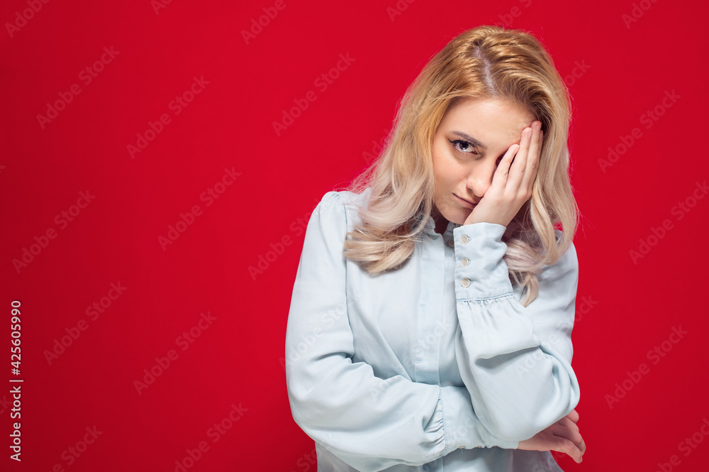 Ashamed woman covering face with hand. Shame, isolated on red background. Guilty girl Ashamed woman covering face with hand. Shame, isolated on red background. Guilty girl