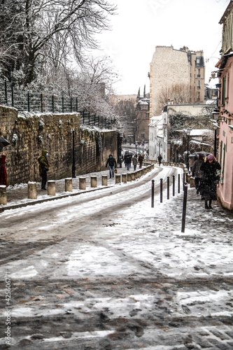 paris montmartre in the winter snowstorm rue de abreuvoir photo