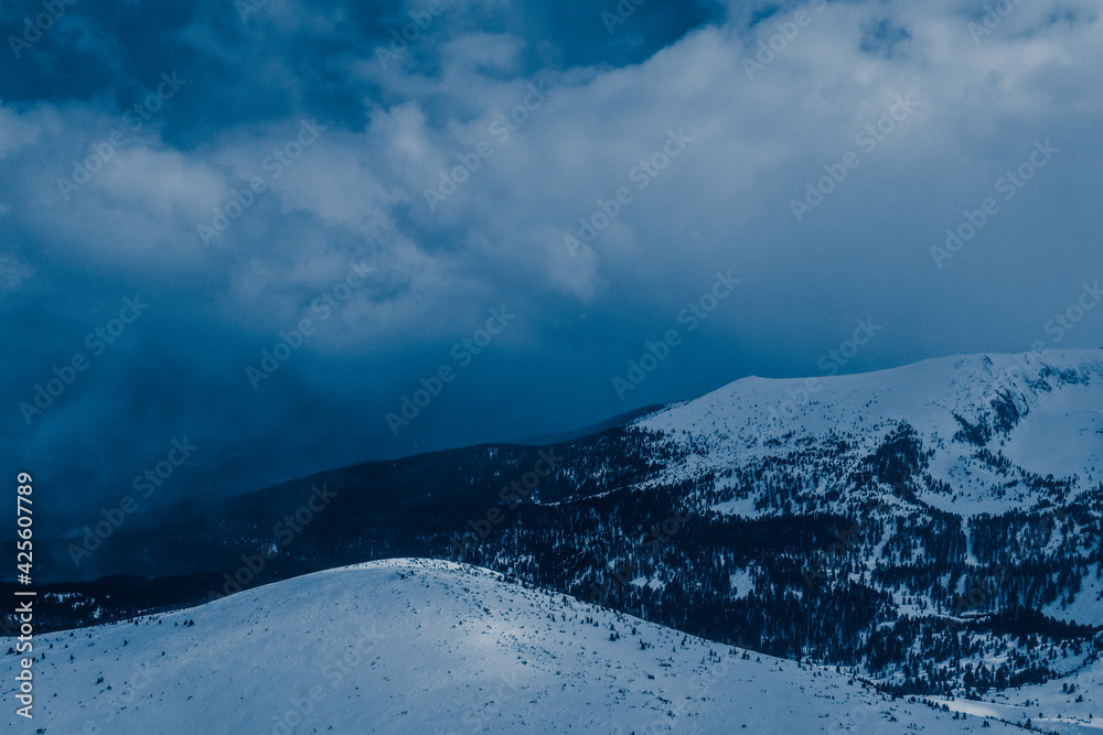 Amazing snow covered mountains, winter. Blue natural background.