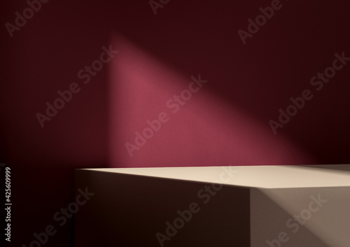Illuminated square display podium for your product. Burgundy red wall in background.