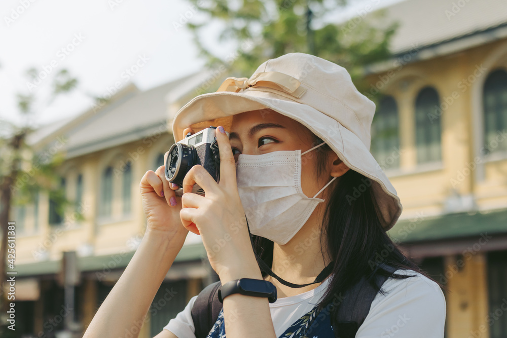 Traveler, travel young asian woman or girl use camera take photo, old town street, city tourism on happy sunny day..Backpacker tourist, holiday trip, summer or vacation, hobby concept.
