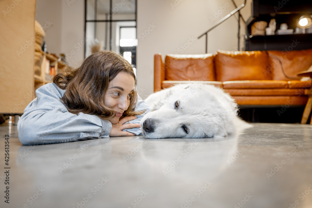 Happy woman with a dog at home