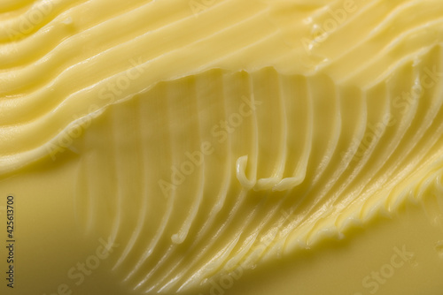Grooves and swirls made by a kitchen knife taking margarine to spread.