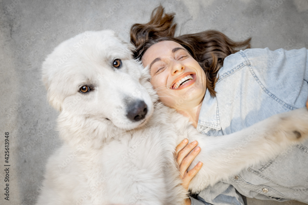 Woman with her dog lying together Woman with her dog lying together