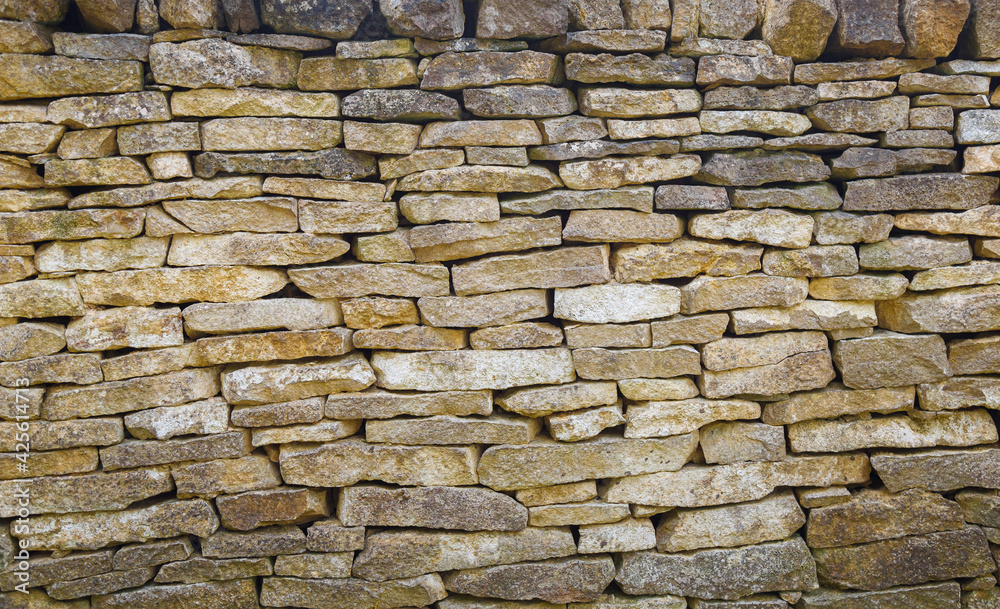 Fototapeta premium View of empty old dry stone wall background with copy space