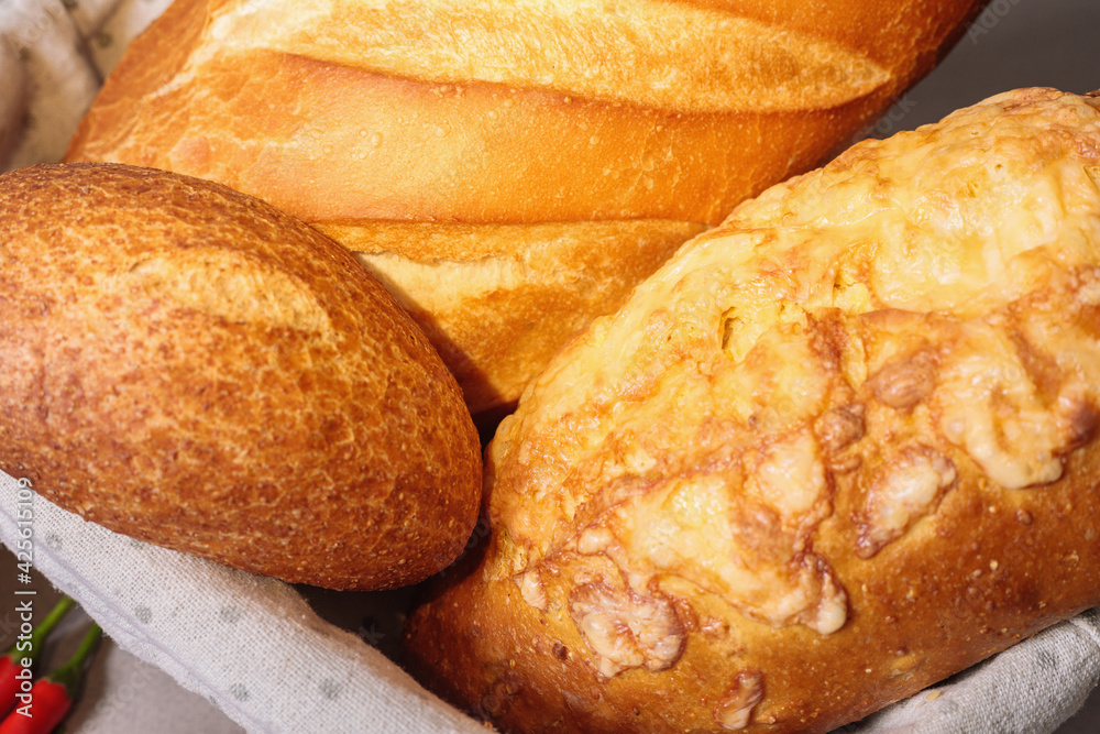 Fresh bread in a basket on a table with a fried crust.