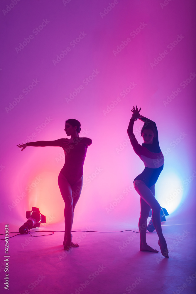 The two modern ballet dancers in black and red bodysuit, studio