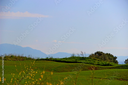 golf courses with mountains in the background