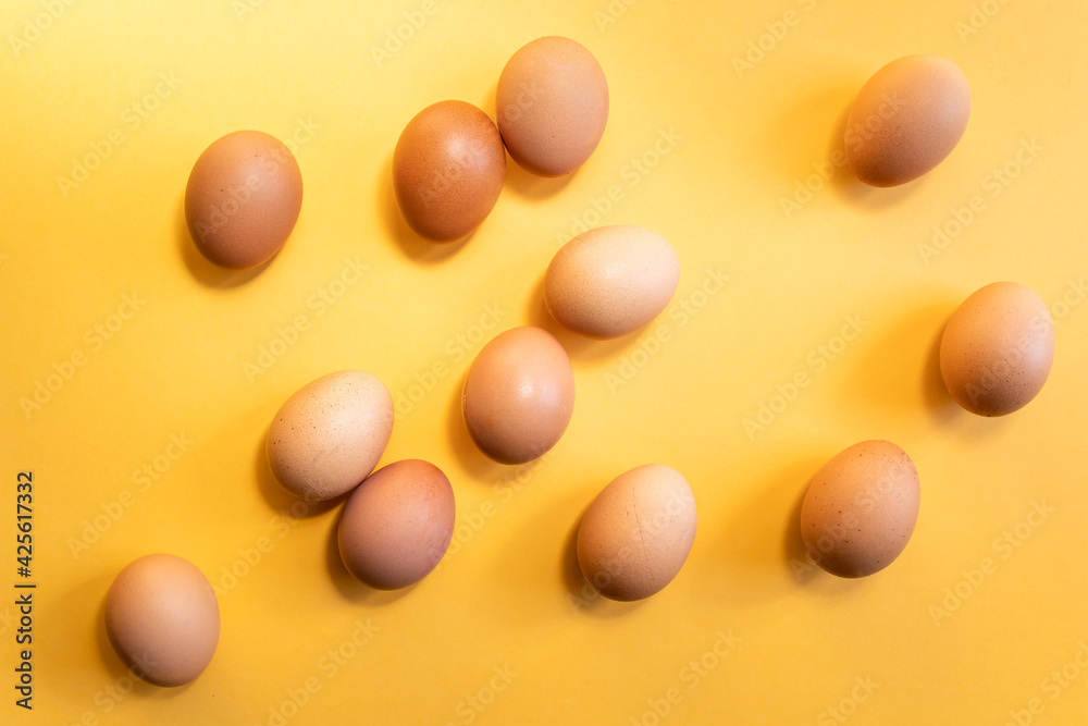 Group of fresh eggs on yellow background. Easter concept. Group of fresh eggs on yellow background. Easter concept.