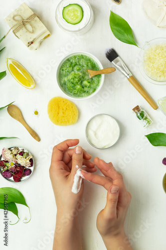 Handmade cream with organic natural ingredients like herbs, flowers, lemon, oil woman hands