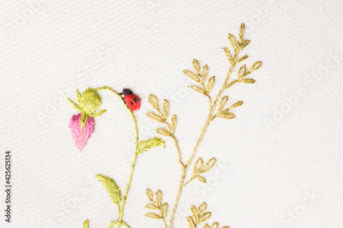 fragment of hand embroidery of meadow flowers