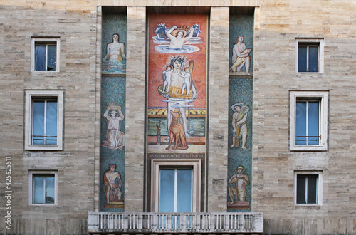 Facade with mosaics of the Fascist-style INPS building in Piazza Augusto Imperatore in Rome, Inscription: Rome originated from Romulus and Remus. photo