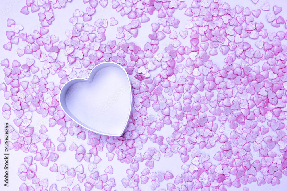 concept of valentine's day, mother's day, wedding, delicate pink background of small hearts in metal shape