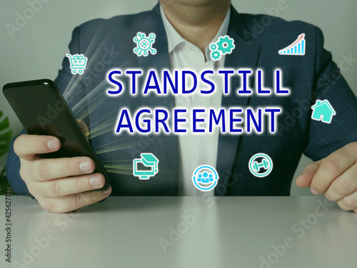  STANDSTILL AGREEMENT phrase on the screen. Broker use cell technologies at office. photo