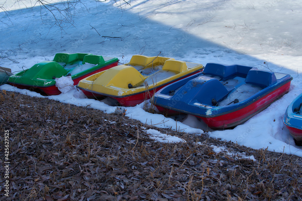 Catamarans frozen in ice on the shore of the lake. Catamarans frozen in ice on the shore of the lake.